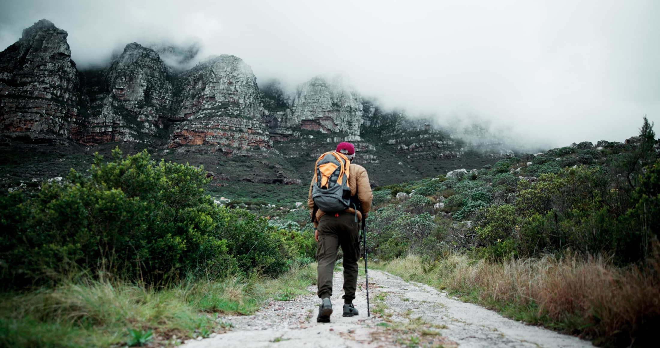 A hiker walking toward misty mountains, representing supported movement from normal toward optimal